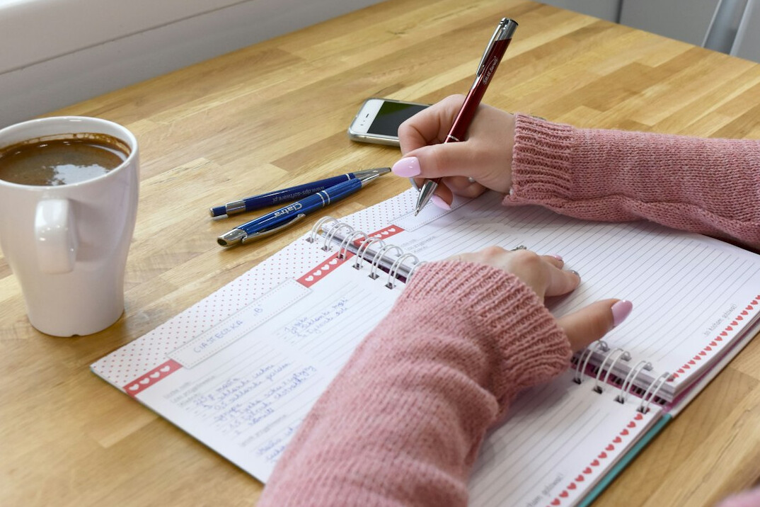 person writing financial goals